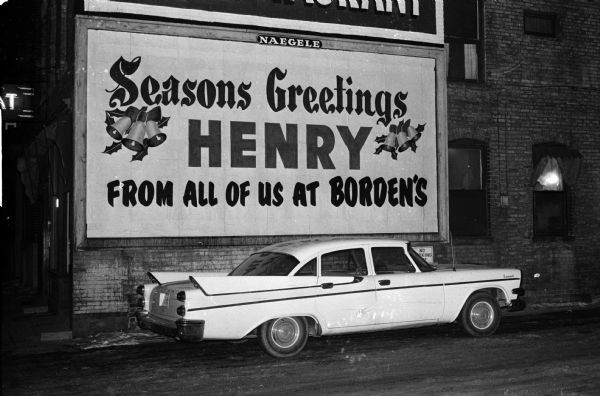Employees at the Madison division of the Borden Company arrange for a billboard to deliver Christmas greetings to their general manager, Henry A. Soldwedel. The billboard space was on a building next to the Borden office across from Soldwedel's office. It said "Seasons Greeting Henry From All Of Us at Bordens."