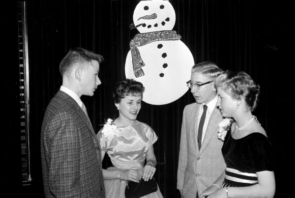A record number of 216 youths attended the third annual holiday formal held for teenage sons and daughters of Elks Club members and their guests. Roger Holten's orchestra played for the dancers. Two couples in attendance include John Schweers and Mina Sparr (left) and Rene Burkhalter and Peggy Moore.
