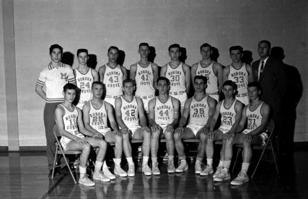 This Monona Grove High School basketball team will try to take over undisputed first place in the Badger Conference when it plays undefeated Monroe. Monona Grove players left to right are: First row: Gary Davis, Denny Howe, Elmer (Buz) Garey, Don Thompson, Mike Cloutier, Gene Davis, Fred Gillette. Second row: Manager Joe Varese, Bob LaHale, Jim Griffin, Harold Anderson, Bill Rameker, Keith Sorenson, Louis Brendler, Coach Frank Hlavac.