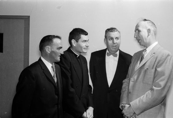 Four men chat before the Construction and General Laborers Local 464 banquet. Left to right are: member Hubert Martinelli; guest Rev. Joseph Brown, assistant rector of St. Paul's Catholic Chapel; member Robert Madigan; and Oscar Richter, secretary-treasurer.