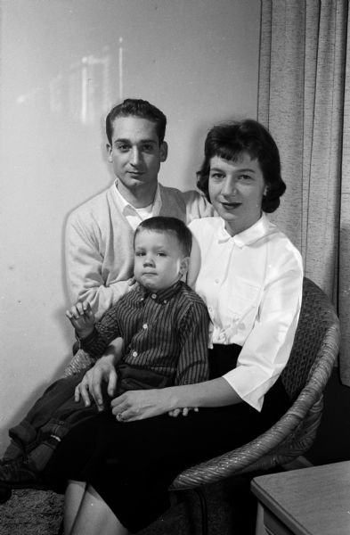 Family portrait of Donald Finn with his wife Diane and their three-year-old son Johnny. Finn is a mid-year graduate of the University of Wisconsin with a degree in electrical engineering. He is also a graduate of Madison Central High School and a Navy veteran.