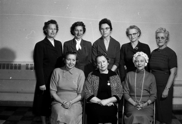 Committee members plan the annual dessert card party and style show for women residents of Westmorland to be held in the auditorium of Our Lady Queen of Peace Catholic Church. Seated, left to right, are: Melba Svee, Mildred Mitchell, and Nona Leichtenberg. Back row, left to right, are: Violet Hagen, Helen Hermanson, Bonnie Beveridge, Elsa Lee, and Jeanette Kneubuehl.
