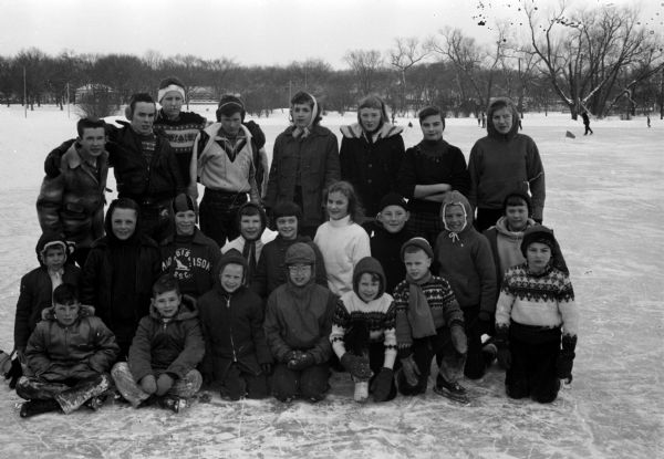 Outdoor group portrait of 23 children and teen city speed skating champions for 1959.