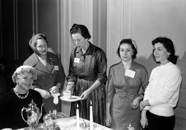 Ferne Shelby, left, a former club president, pours tea at the Who's Who Club anniversary tea at the YWCA, 122 State Street. Others are, left to right: Anna Buchanan, Martha Nordstrom, Valihe Baycu, and Ayla Baskurt.