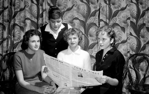 Activities at the Teen-Canteen at the YWCA, 122 State Street, are sponsored by the Junior High Y-Teen clubs in Madison. Reading the East High School paper are, left to right: Marilan Kennard, Bonnie Felt, Karen Collins, and Joyce Sand.