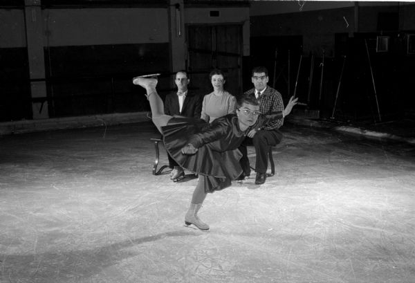 Four members of the Madison Skating Cub have trained skaters that will take part in the club's annual ice show. Winifred Balsley performs a graceful turn in front of Arden and Irene Taylor and her husband, Harold.
