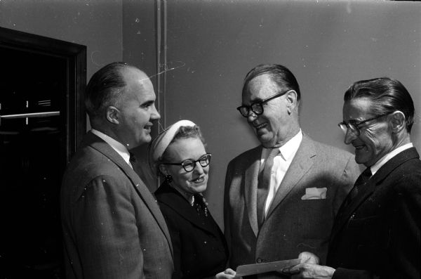 In 1958, Roundy's Fun Fund took in more than $9,600. The money is used to provide fun activities for handicapped children. Members of Roundy's Fun Fund committee shown receiving the check are, from left to right: James Geisler, Dagny Wang, Roundy (Joseph Coughlin), and Bernard Gill.
