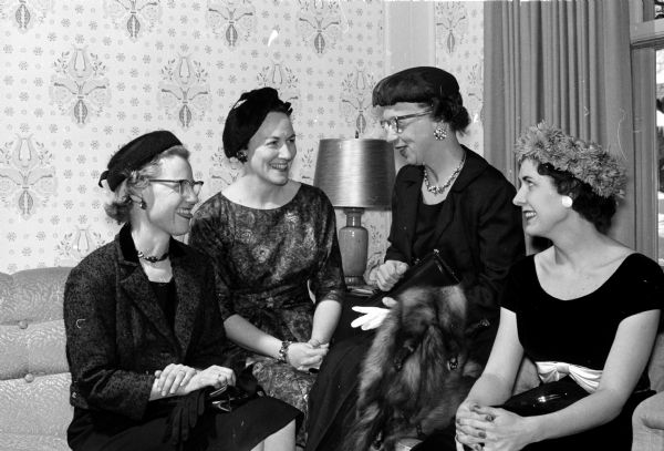 Isabel Hughes, Alice Kirkpatrick, Jeanette Thomas and Mrs. B.D. Craig visiting before the seventh Sigma Alpha Iota benefit musicale and tea. The event was held at the University of Wisconsin President's home.