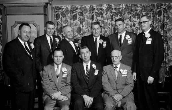 Big Ten coaches gathered to honor Wisconsin's retiring basketball coach Harold "Bud" Foster, seated in the center, at the annual University of Wisconsin basketball banquet. Seated next to Foster are Forrest Anderson of Michigan State (left) and Rollie Williams of Iowa (right). In the back row, left to right, are: Joe Dienhert of Purdue, William Rohr of Northwestern, Osborne Cowles of Minnesota, Ray Eddy of Purdue, William Perigo of Michigan, and Waldo Fisher of Northwestern.