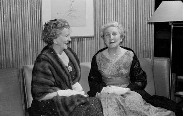 Mabel Lewis and Helen John chat in the lobby of the Memorial Union before the Matrix banquet of Theta Sigma Phi journalism sorority.
