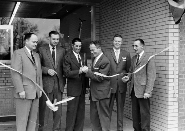 Pictured at the ribbon-cutting ceremony at the Kroger Company's new store at 4100 Monona Drive are, left to right: L.P. Martin, Kroger Co. vice-president; Wallace Entwistle, building inspector superintendent of Blooming Grove; Edwin Kurt, Blooming Grove supervisor; Gene Rankin, Monona village president; Douglas Woolever, manager of the new store, and Carl Shipley, Kroger Co. district manager.