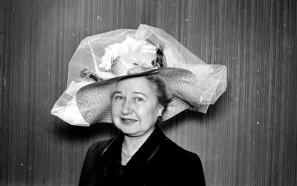 Original colorful hats of all types and designs appeared at the spring "Mad Hat" luncheon at the Blackhawk Country Club. Ellsworth Mack, one of the hostesses, wore a large brimmed straw hat with ribbons, tulle and jewels.  
