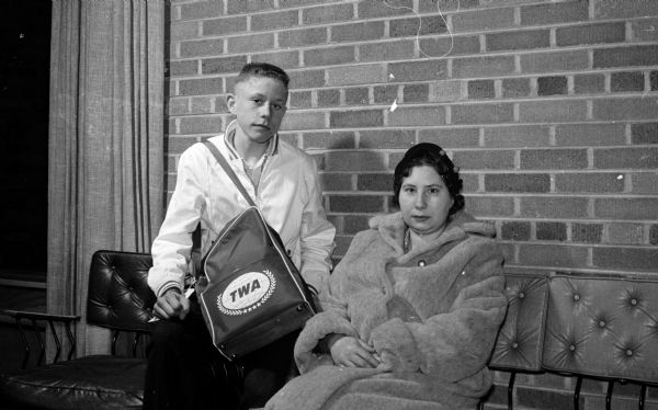 Newspaper carrier Donald Fay, 15, of Edgerton is the winner of the Young Columbus trip to Italy sponsored by the <i>Wisconsin State Journal</i> and its Sunday supplement, Parade Magazine. He is shown here with his mother, Mrs. Victor Fay, waiting for his plane in the Madison airport.