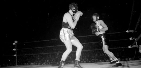 University of Wisconsin boxer Ron Marshall (right) and Norm Ygnatowicz of Idaho State in their 147-pound match at the UW fieldhouse.