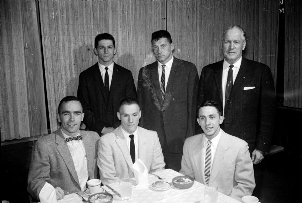 Group portrait of special honors recipients at the annual University of Wisconsin boxing banquet. Seated, left to right, are: Bill Sensiba, Howard McCaffrey, and Phil Gokey. Standing, left to right, are: Charlie Mohr, Tom Wiesner, and coach Vern Woodward.
