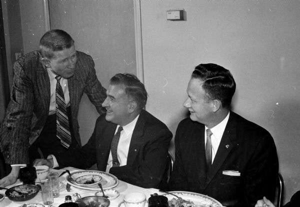 Shown in conversation at the Madison area bankers meeting are, left to right, Richard Quinn, Carl W. Anderson, and David Paterson.