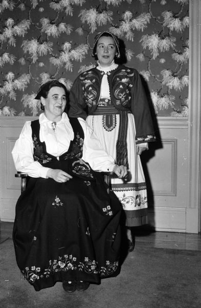 Costumes from other lands were featured at the First Madison YWCA Folk Festival and Fair. Shown modeling Norwegian dresses are, left to right: Eleanor Nerdrum and Elizabeth Morton.