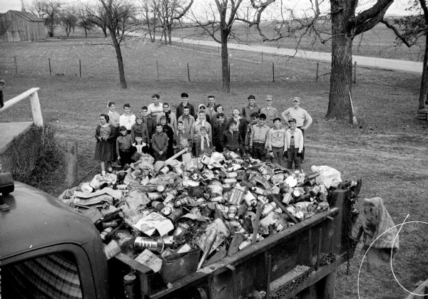 Thirty-three Sun Prairie 4-H youngsters are shown with one of four truckloads of trash they picked up along area highways.