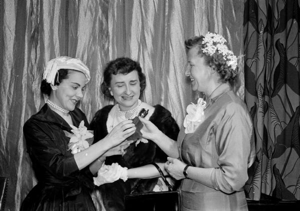 Advice columnist Ann Landers is shown with two writers who received awards at the Ladies of the Press breakfast. Standing left to right are: Ann Landers, Mrs. Charles Temby, and Virginia Kahl.