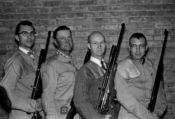 Members of the Madison American Legion four-man rifle team are shown with their rifles. They were recently declared the winner of the state contest held at Watertown. The champions are, left to right: Rev. Alvin Pinke, Elmer Schult, Jerry Moen, and Vernon Herr.