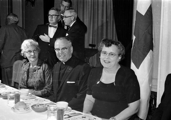 Among the attendees at the 50th anniversary meeting of the Dane County chapter of the American Red Cross are, left to right, Ruth Meloy; Ferdinand A. Mack, pastor of St. Bernard's Catholic Church, Middleton; and Wilma Cox.