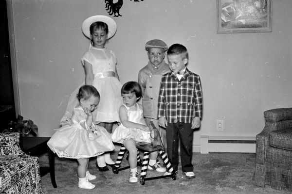 Children model clothing at the benefit style show of the Middleton Opti-Mrs. Club. Left to right are Kathy and Chris Szczupakiewicz, Sarah Lantz, John Blindauer, and George Johnson.