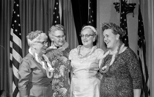 Four women wearing Hawaiian leis gather at the spring luncheon of the Daughters of the Nile. Left to right are: queen Mrs. Edward Dodge of Lake Mills, toastmistress Mrs. Loretta Iler, co-chairman Mrs. Myrtte Jessen, and chairman Mrs. Harvey Raasoch.