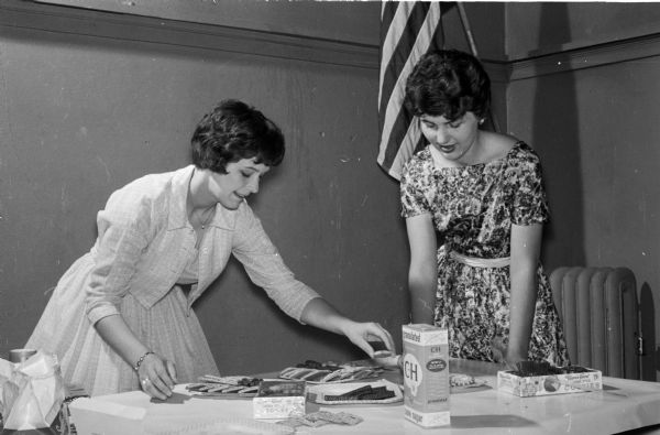 Alderman-Elect Renee Reese (left) and Gale Kocvara, retiring treasurer, gather around the refreshment table during ceremonies for the installation of newly elected East Side Young Mayor's council.