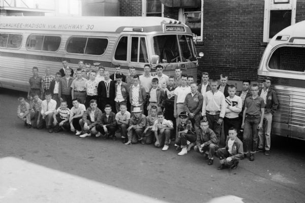 44 young carrier salesmen for the <i>Wisconsin State Journal</i> posing in front of a bus that will take them off "for three days packed full of fun in Chicago." A place on the tour was won by each boy by obtaining the most number of State Journal customers for a magazine-newspaper subscription plan.