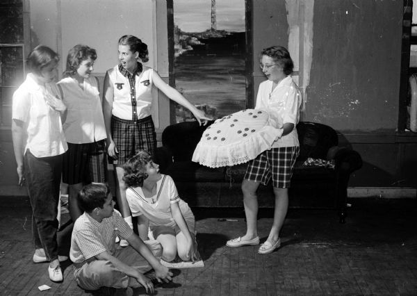 Six Madison area teenage members of the Youth Summer Theater rehearse a scene before 30 performances of "The Magic Shoes." The plays were performed at parks and playgrounds. Standing left to right, are: Alice Kissane, Marilyn Kennard, Kay Miller, and Debbie Mitchell. Seated are Ron Paskin and Sue Tuttle.