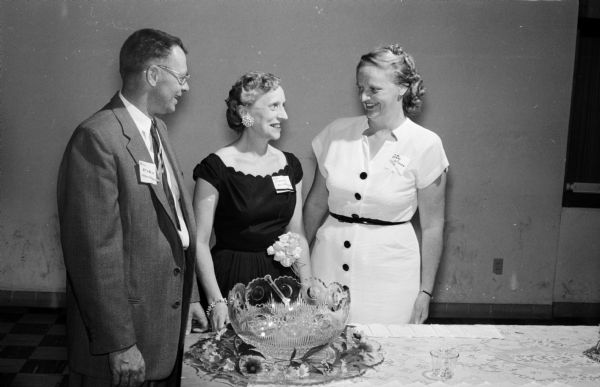 Dane County foster parents are honored during the statewide observance of Foster Parents' Week. Approximately 200 foster parents attended the meeting held in the Our Lady Queen of Peace Catholic Church basement. Shown (left to right) are William Staven, Mrs. Marvel Albright, and Mrs. William Staven.