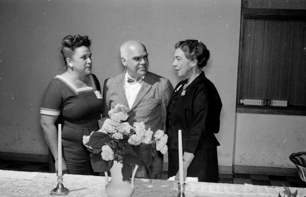 Dane County foster parents are honored during the statewide observance of Foster Parents' Week. Approximately 200 foster parents attend the meeting held in the Our Lady Queen of Peace Catholic Church basement. Shown (left to right) are Mrs. Paull Breuning, member of the planning committee; Lt. Gov. Philleo Nash, main speaker; and Mrs. Evelyn Owens, chairman of the Community Welfare Council's foster home committee.