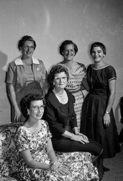 The Madison women's city golf tournament banquet is held at Nakoma County Club. The tournament planning committee includes (shown left to right), seated, Mrs. Wallace Jopke, Public Links; Mrs. Harold Rasmussen, Nakoma County Club; standing, Mrs. Howard Herrick, Nakoma County Club; Mrs. Russell Teckemeyer, Maple Bluff County Club; and Lorraine Burke, Blackhawk County Club.