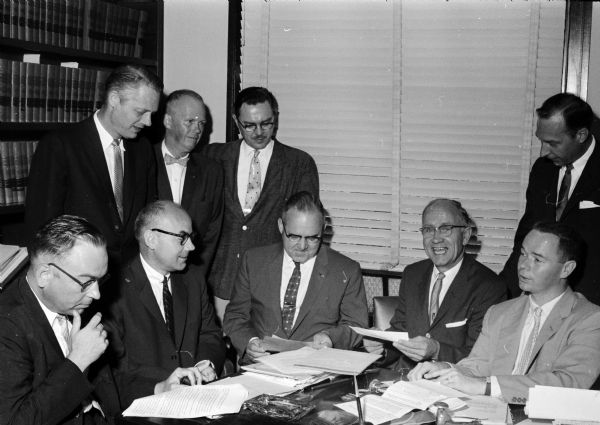 A check in the amount of $238,500 for the purchase of the old United Community Chest headquarters at 14 West Johnson Street was presented to Chest officials by the officials of Bethel Lutheran Church. 

From left to right are, John J. Jenswold, attorney for the church; the Reverend Morris Wee, pastor of the church; R. A. Eissfeldt, past president of the Community Chest; Francis J. Bowman, chairman of the Chest building committee; Ralph W. Metz, executive secretary of the Chest; Ted Meloy, Community Chest president; Lars M. Hanson, church president; Warren A. Hedlin, church secretary and Frank A. Ross Jr., attorney for the Chest.
