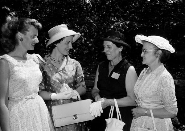 Four guests attend the University League tea in honor of the wives of visiting summer session faculty at the University of Wisconsin. Pictured are Mrs. Althea Harman, Mrs. G. Fichera of Rome, Italy, Mrs. E. Hopf of Indiana University, and Mrs. Louise Langer.