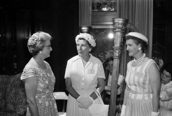 Mrs. Elizabeth Sarig and Mrs. Florence Dvorak visit with Mrs. Allen Fisher of Ontario, Canada at the University League tea to honor wives of visiting summer session faculty members at the University of Wisconsin.