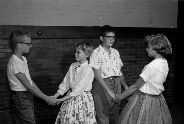 Learning the steps to the "Mexican Hat Rack" dance are, left to right: Michael Kiley, 529 West Mifflin Street; Linda Edds, 116 North Broom Street and her brother, Tom; and Catherine Landsness, 230 Waubesa Street.