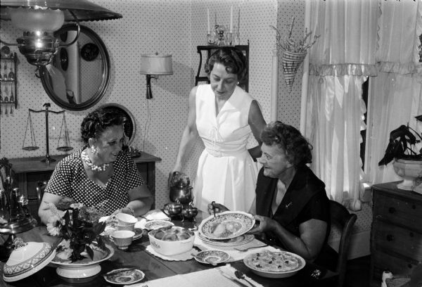 Group portrait of three judges for the <I>Wisconsin State Journal's</I> annual Cook Book Recipe Contest. Left to right are Mrs. Alice Ferguson, home service director of Madison Gas and Electric Company; Mrs. Margaret Nelson, teacher-coordinator at Madison Vocational and Adult school; and Miss Loreen Jacobson, home economics director of Wisconsin Power and Light Company.