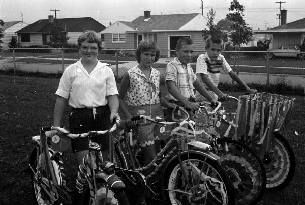 Shown posing with their decorated bicycles during the Eastmorland bike parade are (L-R): Joanne Pederson, Donna Pollock, James Boerke, and Robert Boeing.