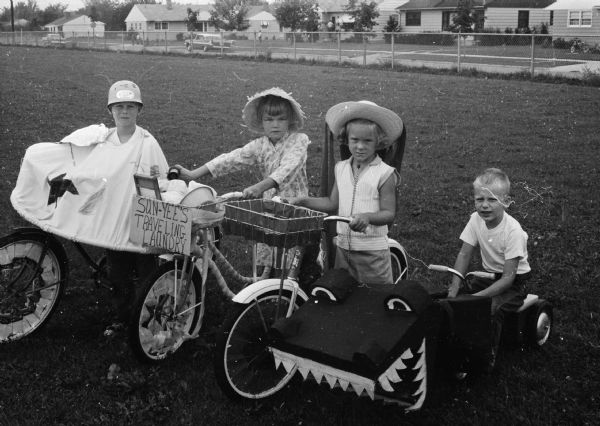 Bicycles are decorated as part of the Eastmorland bike parade. The bikes belong to and were decorated by, from left to right: Jimmy Walsh, Mindy Peck, Lynne Jefferson and Todd Siemers in the 4-6 age group.