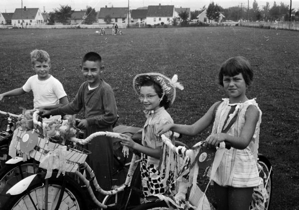 Children in the 6-8 age group decorated themselves as well as their bicycles for the Eastmorland bike parade. They include, from left, Karl Jones, Saverio Maglio, Louise Remick and Nancy Larson.