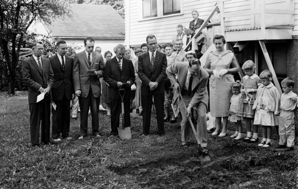 Andrew Rice, Sunday School superintendent, is shown breaking ground for the new two-story $38,000 church school addition of Trousdale Methodist Church at 1125 Vilas Avenue. Also pictured are, from left, Reverend Raymond D. Robinson, minister; Dale Bruhn, lay leader; Earl Edwards, chairman of the building committee; Wesley West, chairman of the church board of trustees; Stan Bokelmann, contractor, and Gertrude Hughes, president of the Women's Society of Christian Service.