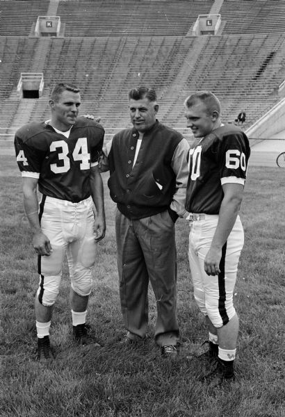 Head Coach Milt Bruhn is flanked by Wisconsin football co-captains Bob Zeman of Wheaton Illinois, left, and Jerry (Sparky) Stalcup of Rockford, Illinois.