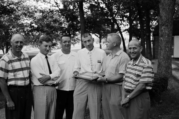 Harold E. (Bud) Foster, center, was the winner of the Madison Service Clubs Olympics golf competition. Also shown, left to right, are: Ed Hobbins, Jack Auringer, Bob Rennebohm and Larry Dosch.