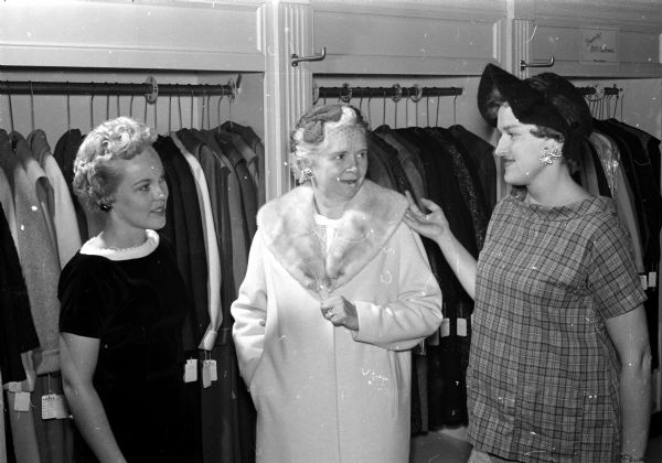 Mrs. Joseph (Delores) Meagher, 214 Standish Court, chairmen of models for the Jaycettes, with Mrs. William L. (Wanda) Doudna, 222 South Owen Drive, left, and Mrs. R. G. Birkemeier, 919 Coumbia Road, center, as they tried on clothes for the Junior Chamber of Commerce benefit fashion show, held at the Wisconsin Union theater on the shore of Lake Mendota.