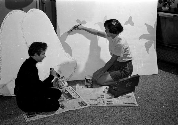 Mrs. John (Janice) Lebedoff, 607 South Orchard Street and Mrs. Gerald (Jacquelyn) Goll, 3617 Eliot Lane, are painting a set for the Jaycettes bridal show segment of their fashion show which benefits children of Wisconsin who have cerebral palsy.