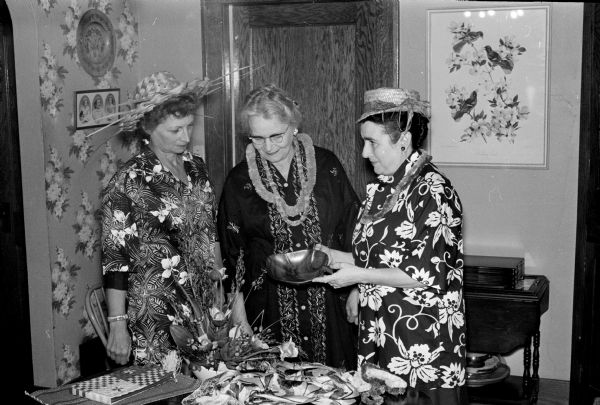 Committee members for the YWCA World Fellowship garden party show off their Hawaiian costumes. Show left to right are: Mrs. C.A. Bishop, Mrs. R.M. Steinhauer, and Mrs. Howard Orians.