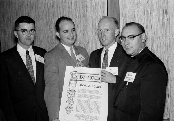 Group portrait of the charter presentation to the Madison Dominic Club. Left to right are: Larry Loomis of St. Paul, Minnesota, vice-president of the state council; William Nolan of St. Paul, president of the state council; John Hendrickson of Madison, past president of the club; and Rev. Victor Falkenstein, assistant at St. James Catholic Church and spiritual director of the club. The Dominic Club is for single Catholic adults.