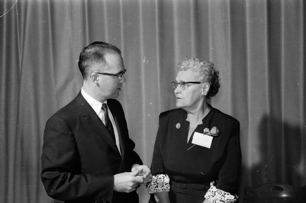 Lloyd Hughes, hospital superintendent, and Alma C. Olson of Belleville attend a recognition ceremony for non-academic employees of University Hospital who have worked more than twenty years or retired recently.