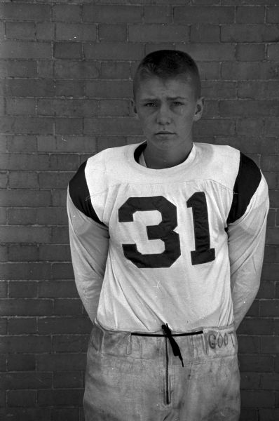 Portrait of Craig Lutey, # 31 on the Wisconsin High School football team. One of 33 images of individual members of the Wisconsin High School football team and the coaches Hal Metzen and Ed Goss.